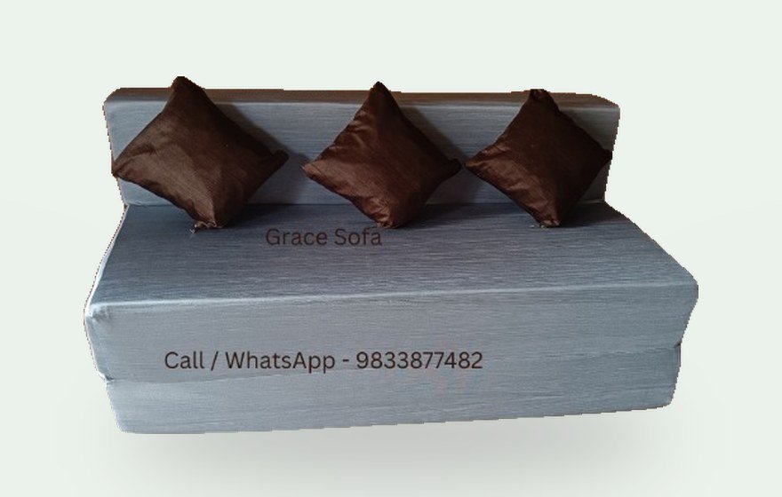 Grey sofa cum bed with brown cushions