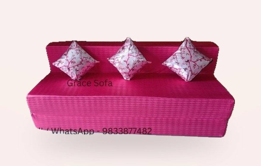 Pink sofa cum bed with floral cushions